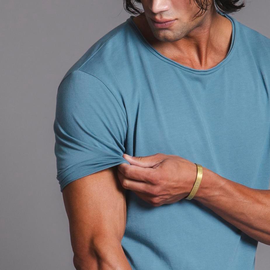Male modeling blue crew neck shirt