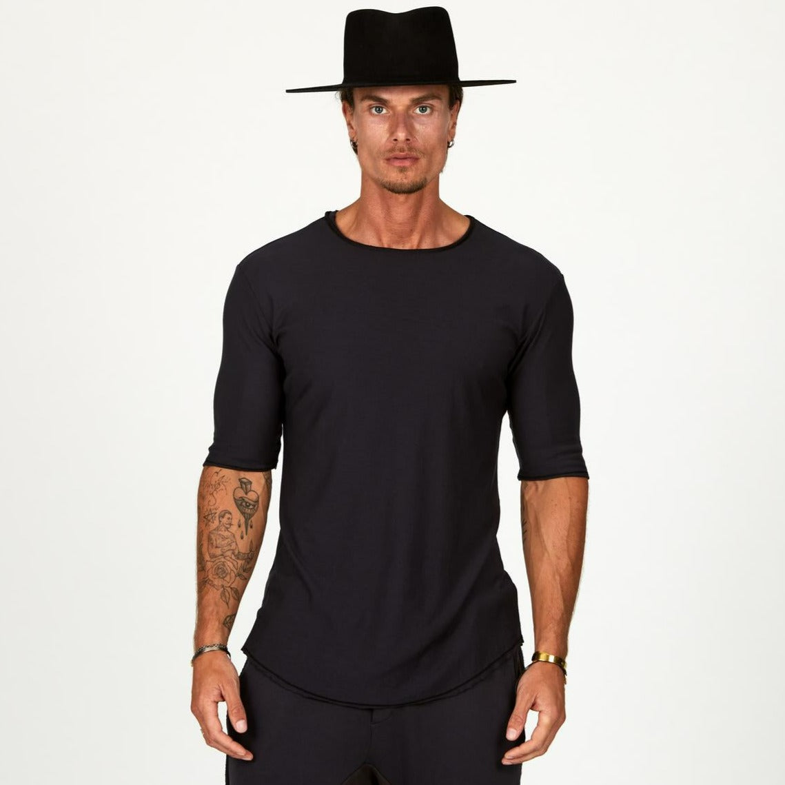 Male modeling black crew neck shirt