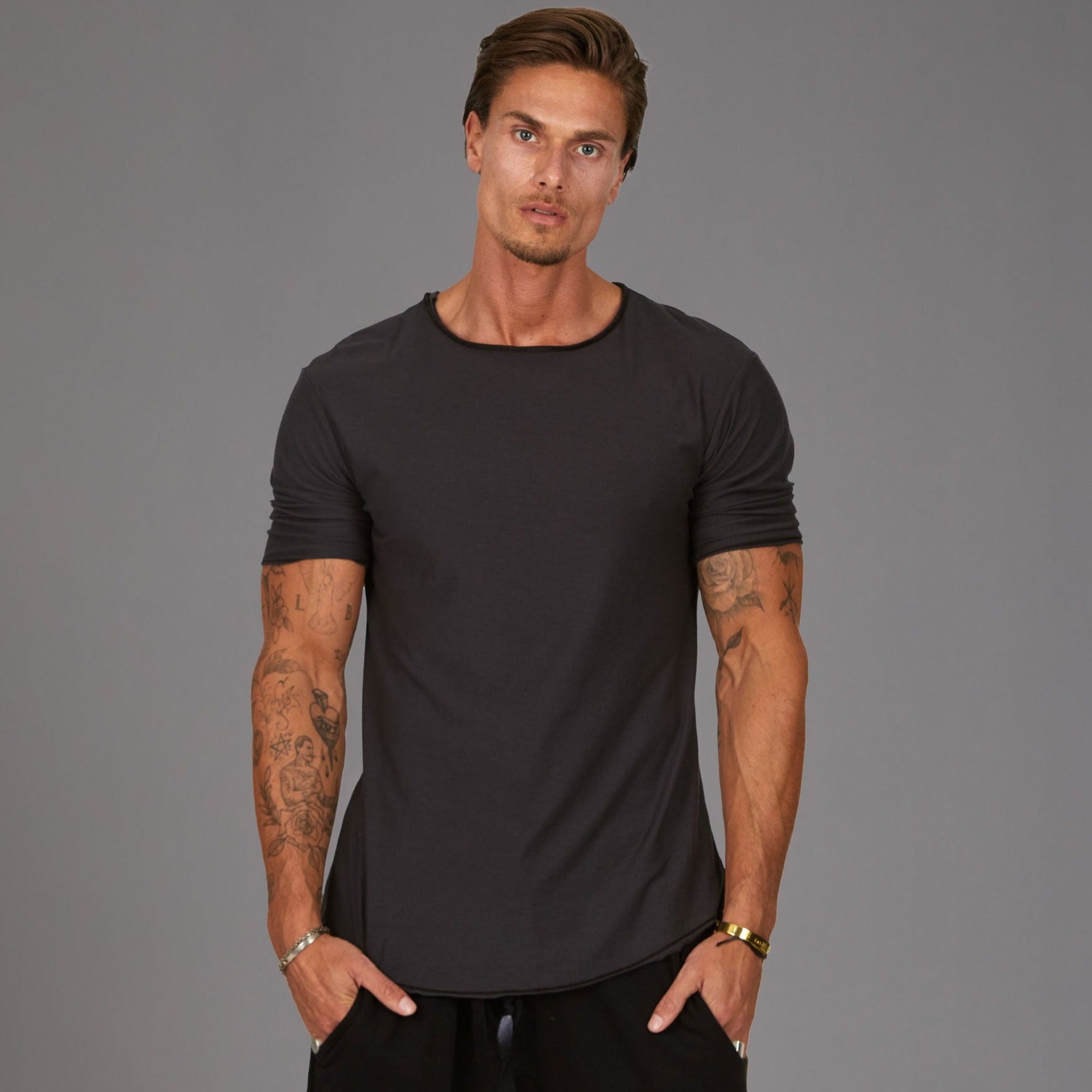 Male modeling grey crew neck shirt