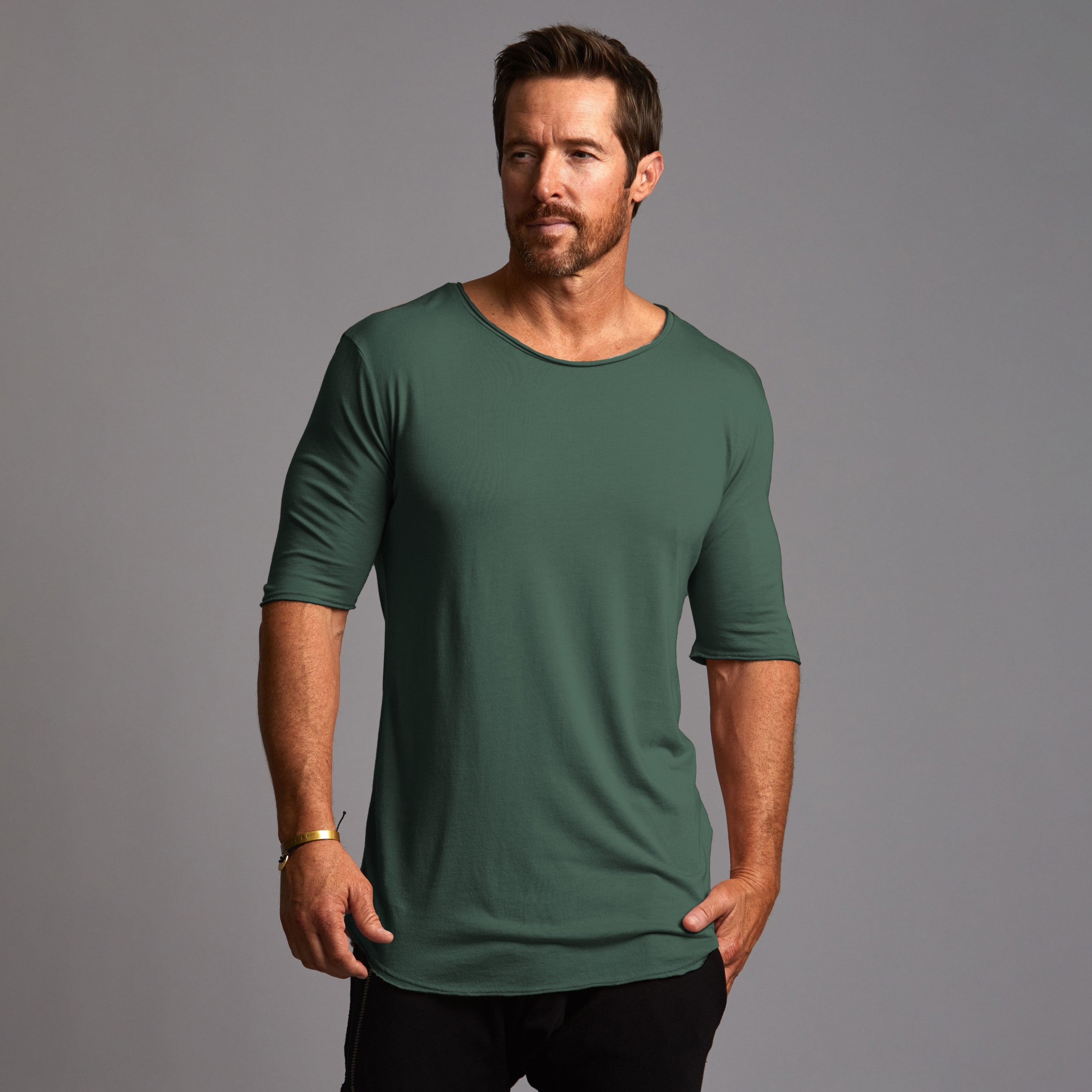 Male modeling green crew shirt