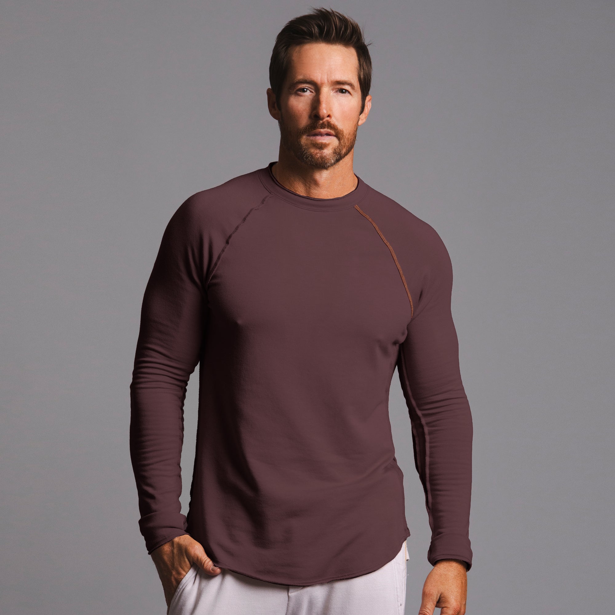 Male modeling long sleeve raglan in brazen
