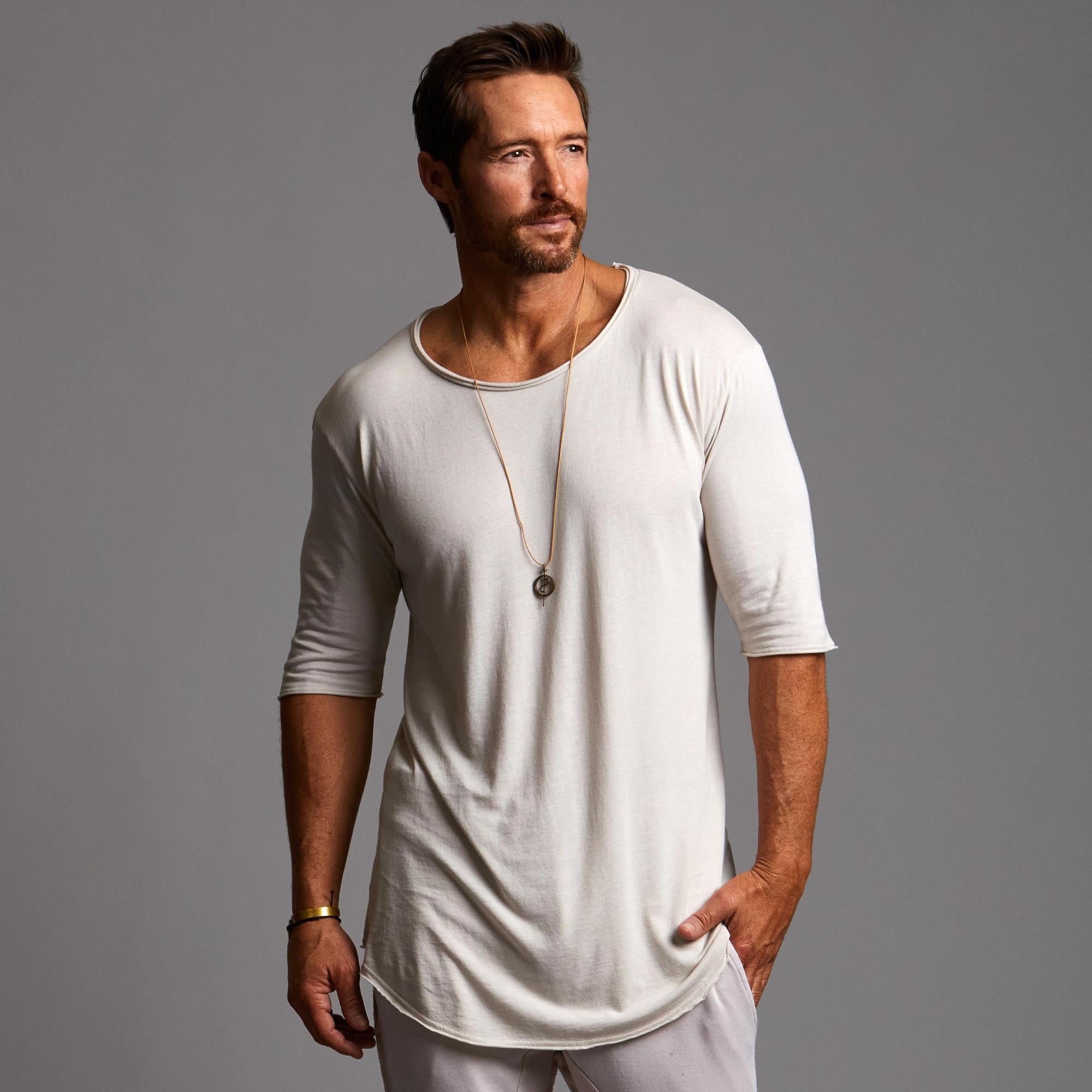 Man modeling a long sleeve shirt in white