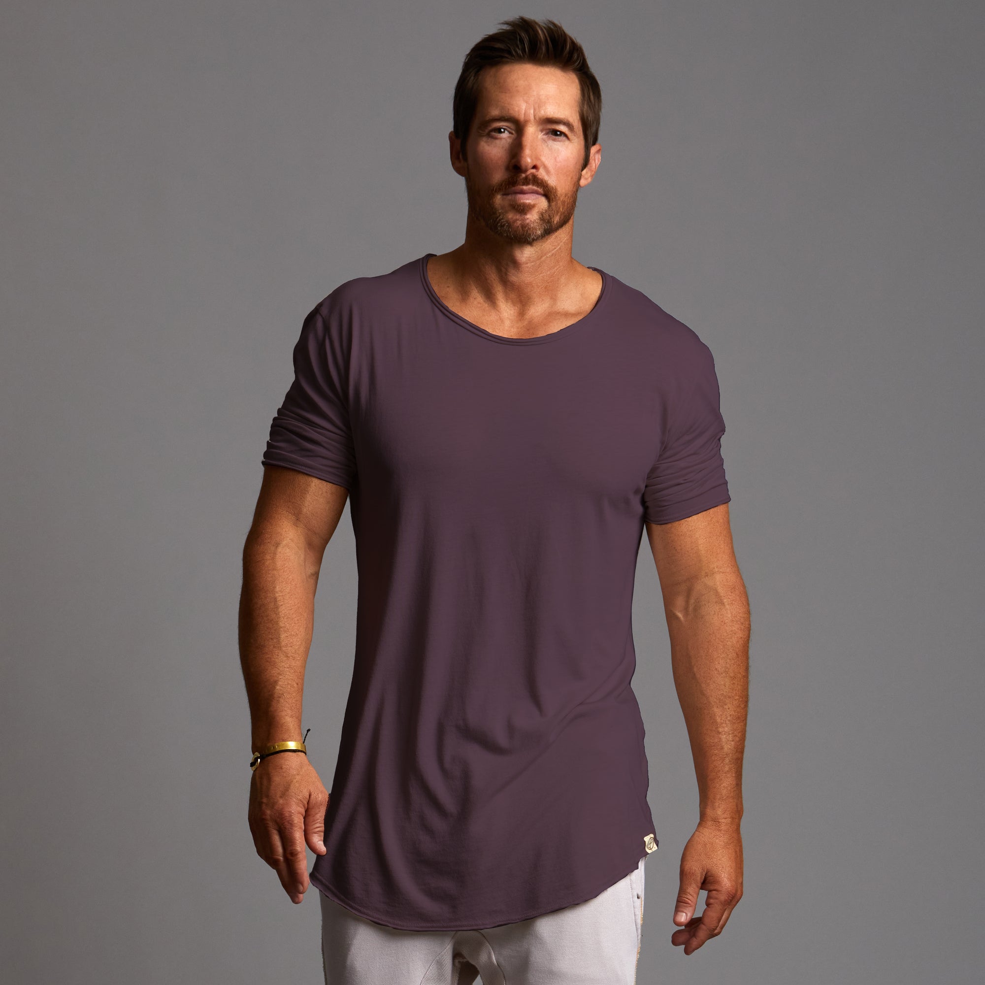 Male modeling purple crew neck shirt